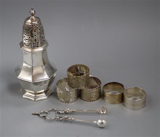 An Edwardian Brittania standard silver sugar caster, London, 1907, a pair of Victorian silver sugar nips and five napkin rings